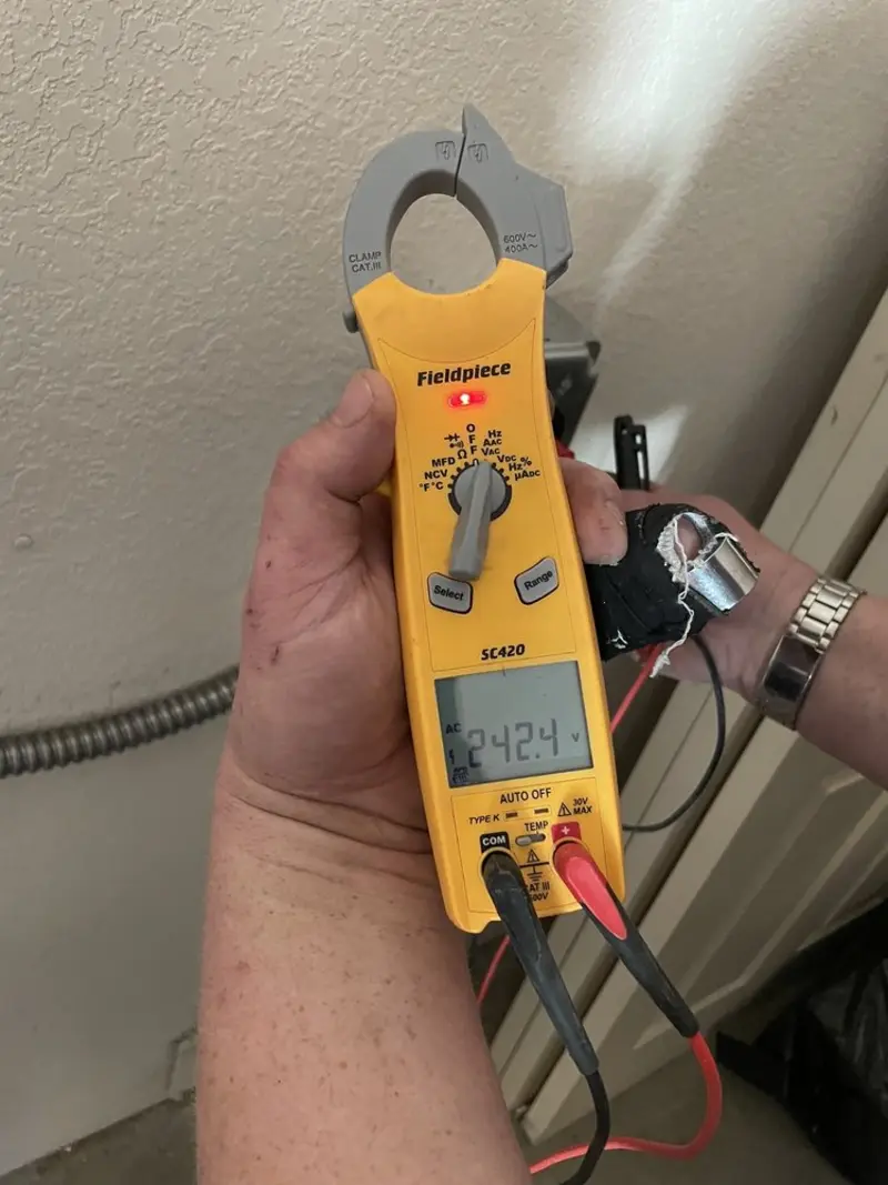 Voltage testing with clamp meter during Generator Installation in Otsego Lake